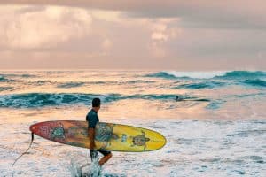 man with surfboard bali beach SP
