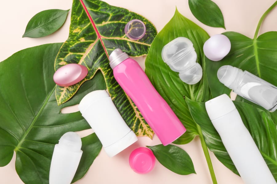 Different deodorants on top of leaves