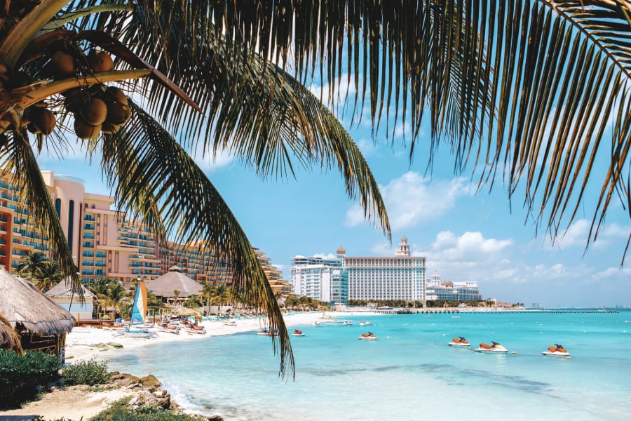 view of cancun resorts with palm trees in foreground