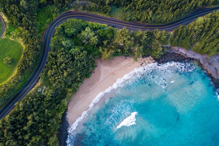Aerial view of the sandy beach and curved asphalt road on the west coast of Maui