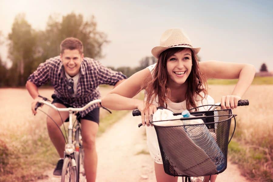 Couple racing on bikes