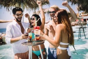 group of friends having fun and partying at pool