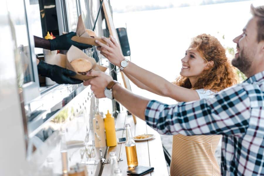 two people getting food from food truck