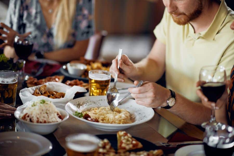 Friends having pasta at restaurant