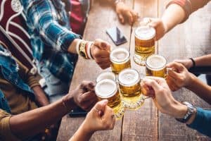 group of friends cheers with beers