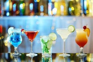 Glasses of tropical cocktails on bar counter