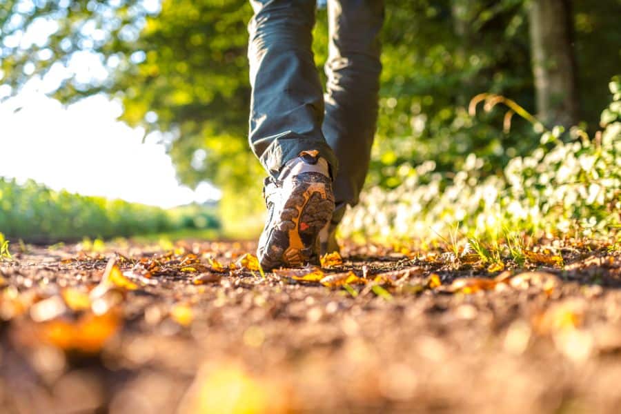 man wearing hiking boots on a nature walk