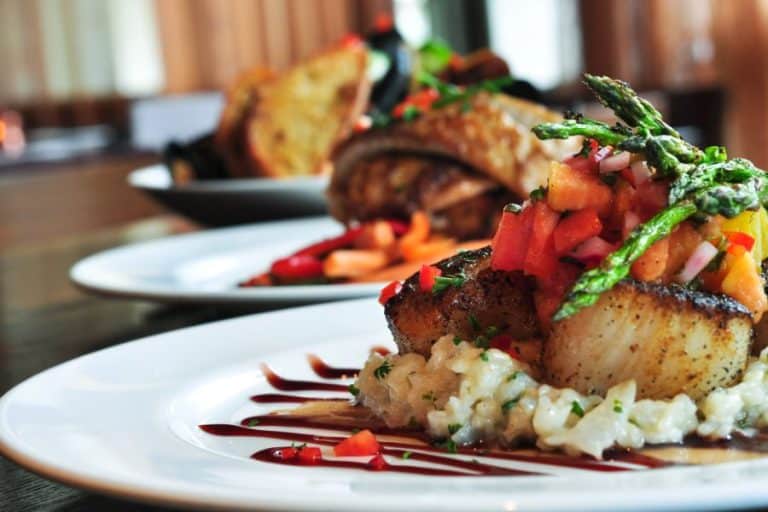plate with seared scallops in fine dining restaurant