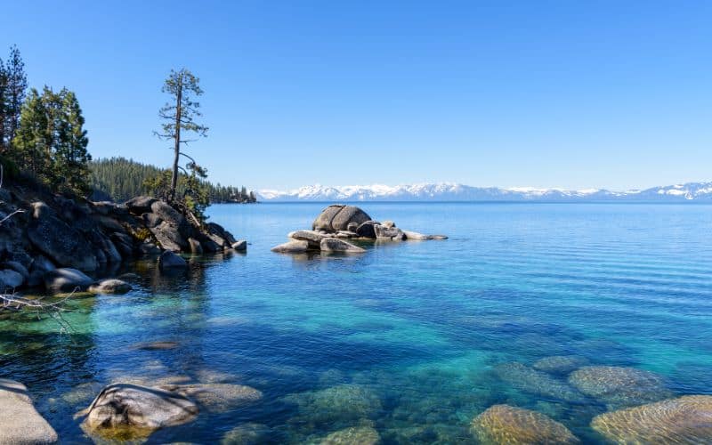 Landscape of blue Lake Tahoe with snowcapped mountains
