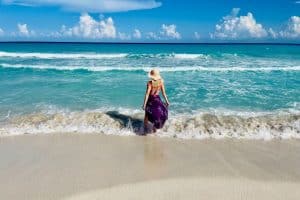 Young white woman walking on the beach Cancun Mexico