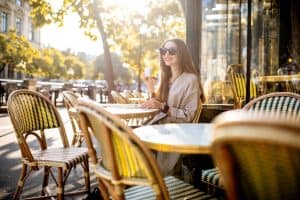 Woman sitting outdoors at the french cafe