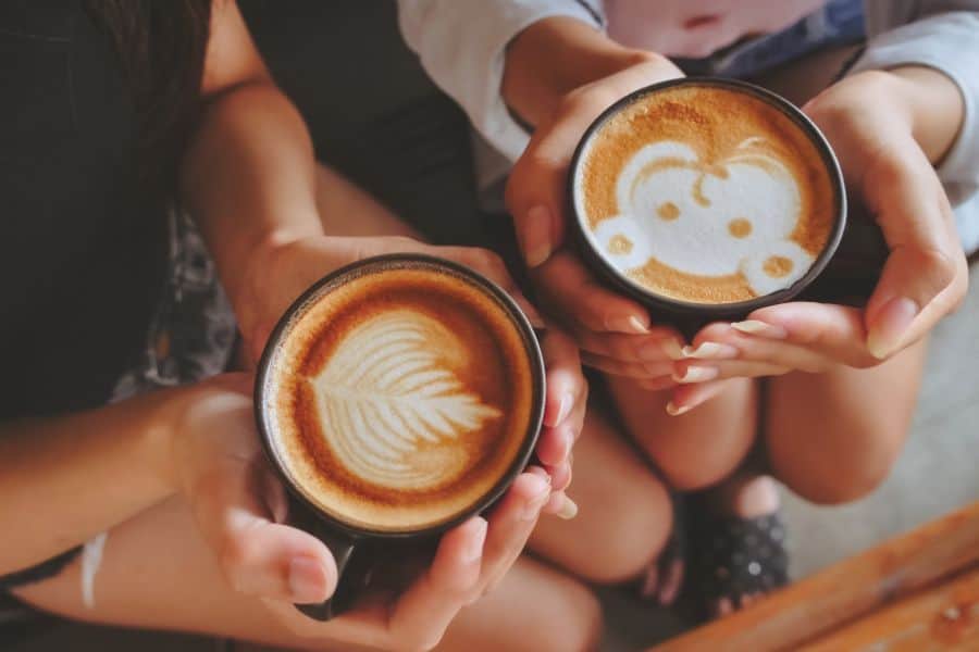 drinking hot coffee with latte art in the cafe