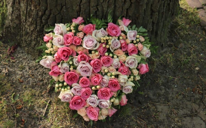 flower arrangement in a heart shape pink and purple roses