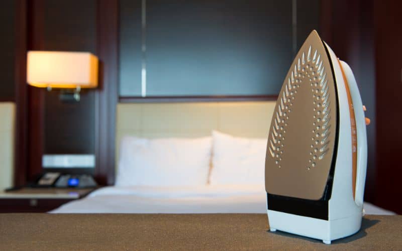 steam iron and ironing board in hotel room