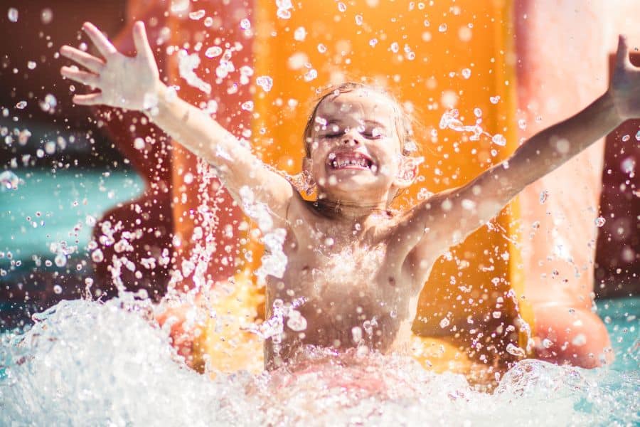 young child on waterpark slide