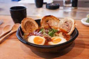 traditional Japanese ramen soup with sliced pork topped with egg