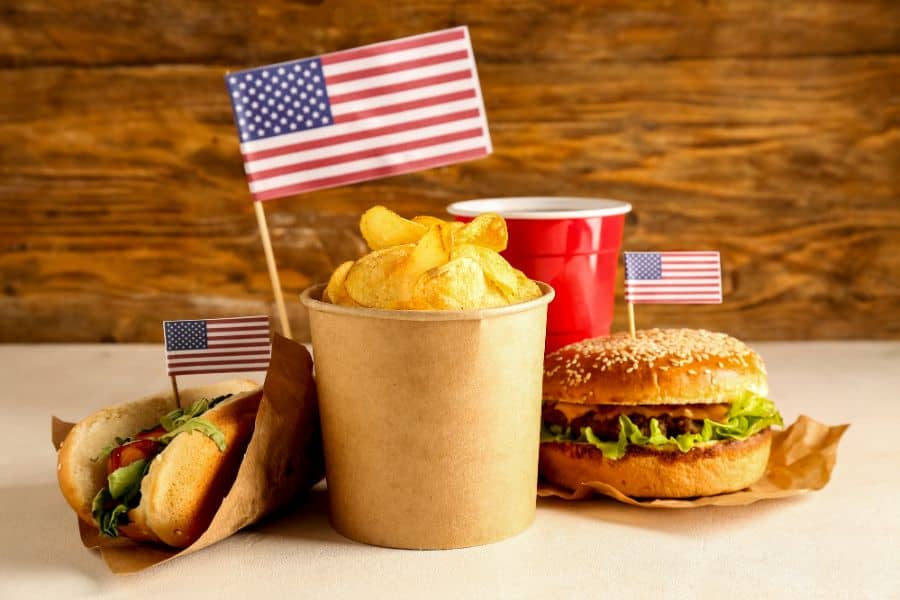 Tasty burger potato chips hot dog and cup of drink american food