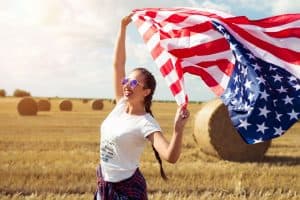 Young beautiful woman holding USA flag