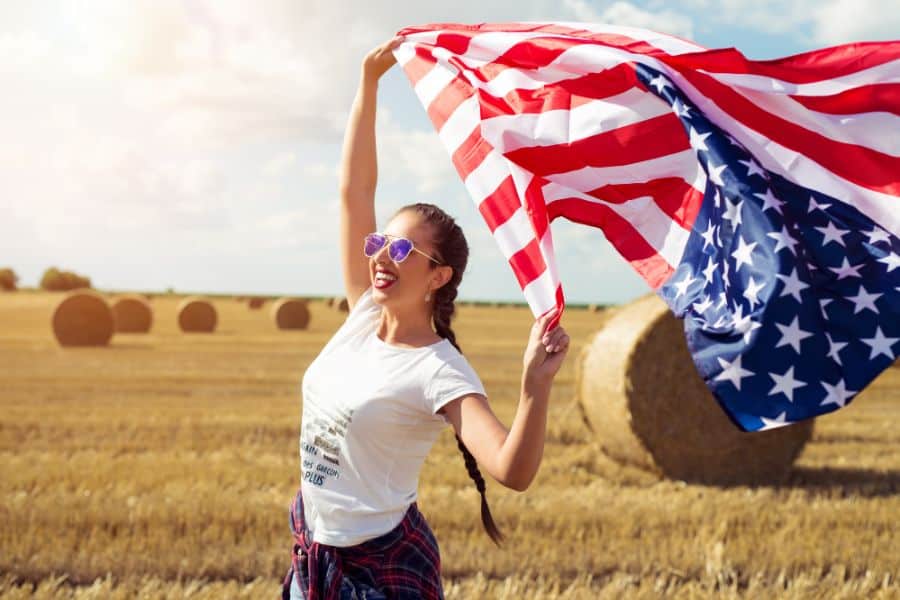 Young beautiful woman holding USA flag