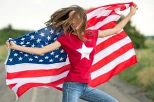 Young happy woman with American flag