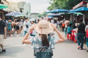 woman solo traveler walking on busy street