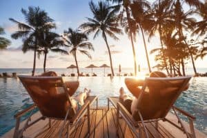 couple relaxing poolside at luxury resort