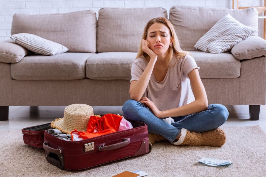 frustrated woman with packed luggage