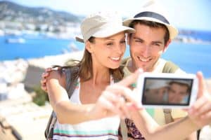 man and woman traveling and taking photos