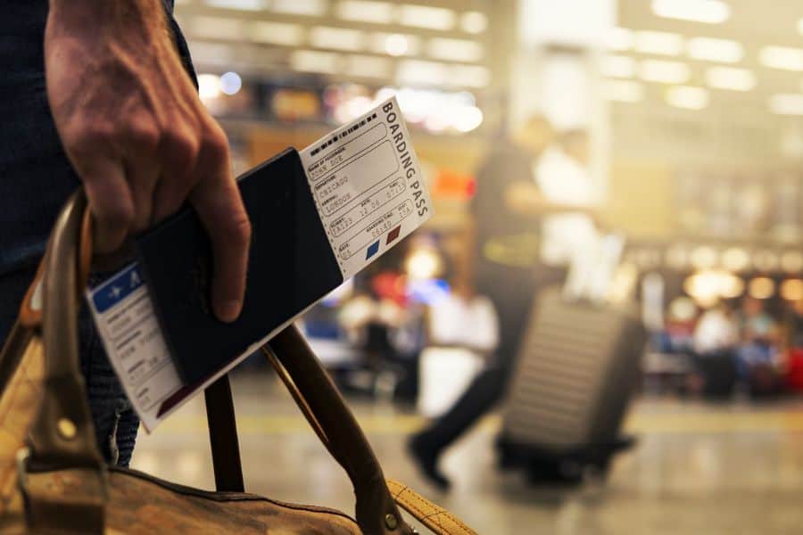 man holding boarding pass ticket and passport sp