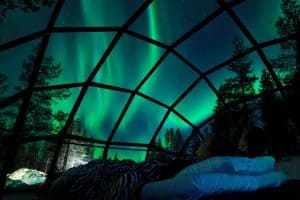 northern lights above snowy landscape in Finland