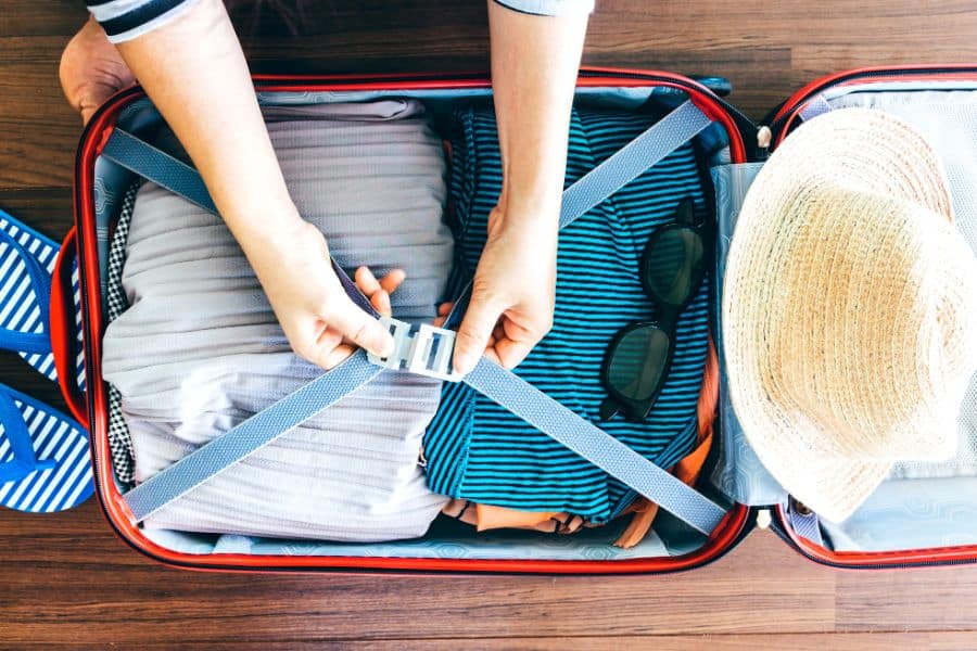 person packing a carry on luggage