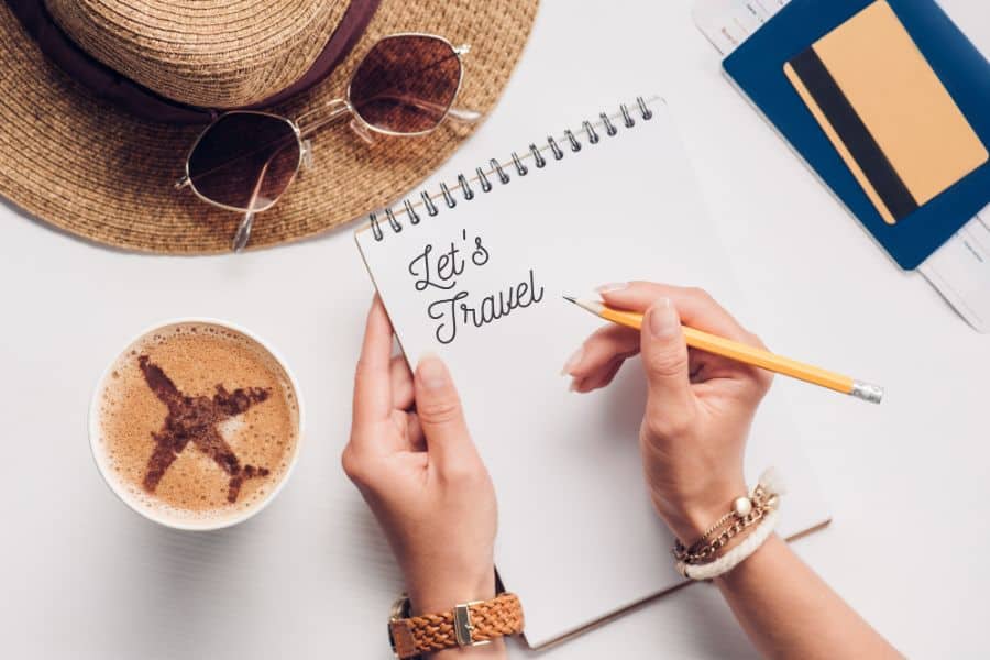 woman with notebook with lets travel