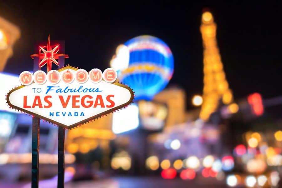 Famous Las Vegas sign at night with Las Vegas Cityscape