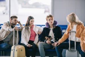 Young friends talking while waiting in airport terminal