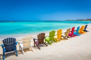 beach with rustic adirondack chairs in Aruba Dutch Antilles