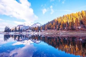 beauitufl autumn landscape with snowcapped mountains and fall foilage