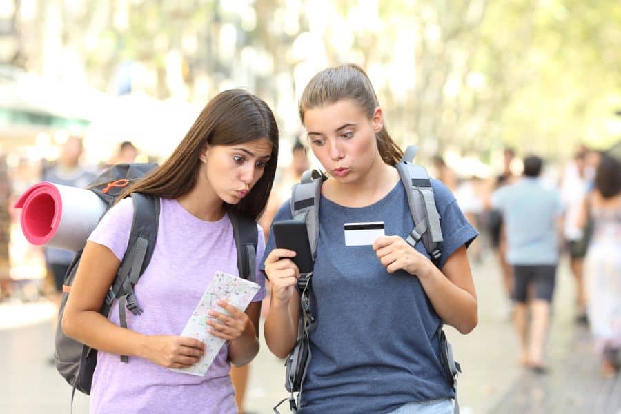 confused tourists holding map and credit card