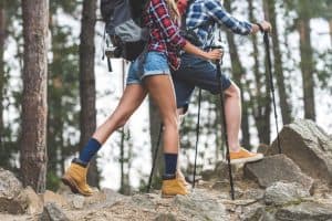 woman and man hiking with full gear