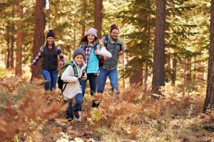 Family enjoying hike in a forest during autumn