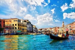 Venice Grand canal with gondolas and Rialto Bridge Italy