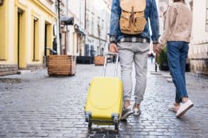 couple holding hands and traveling together