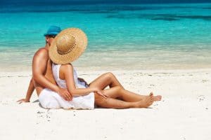 Couple in white relax on a beach