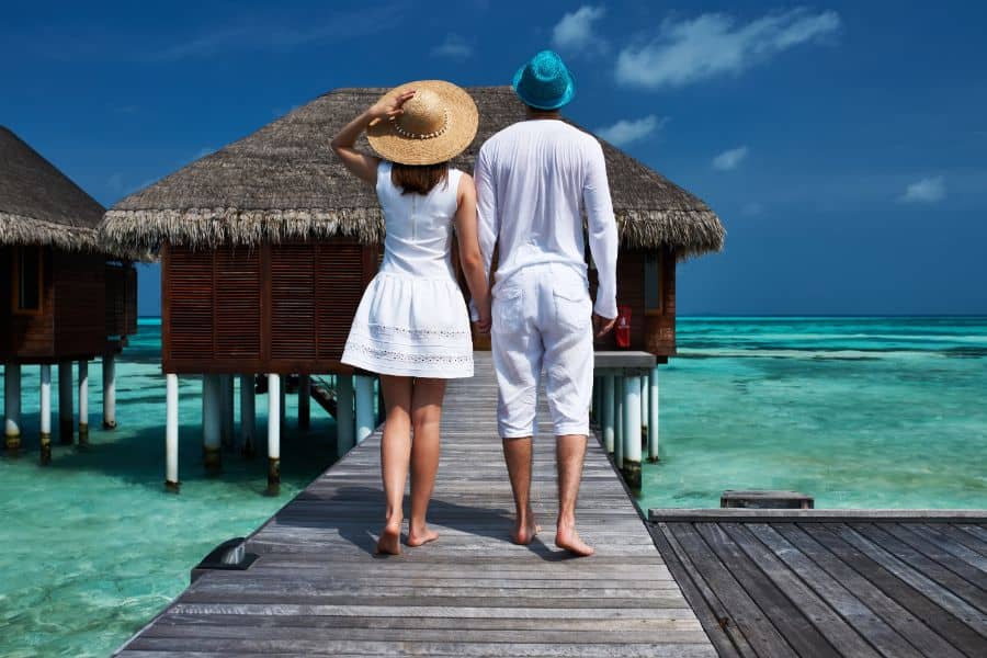 Couple on a beach jetty in the maldives