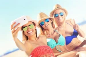 Group of friends taking selfie on the beach