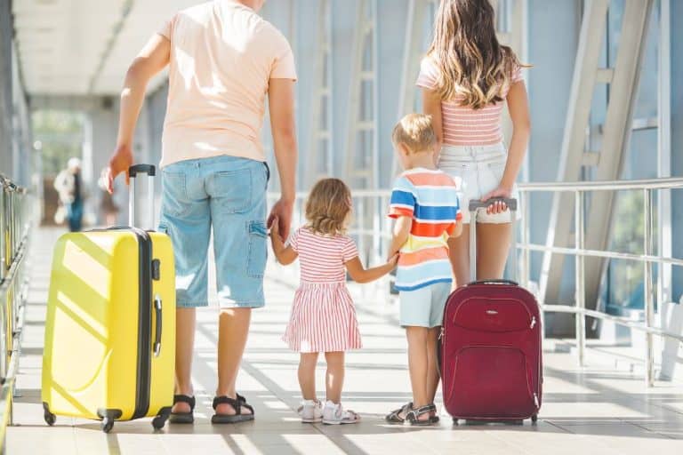 Happy family in airport waiting for departure