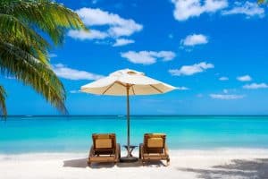 Idyllic white beach in front of the turquoise tropical sea