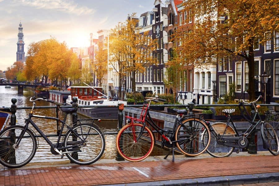 bikes lined up over canal river Amstel amsterdam during fall