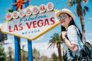 female solo traveler at welcome to las vegas sign