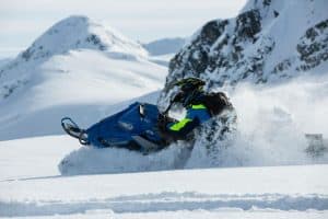 person snowmobiling in a snowy landscape sp