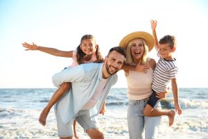 Happy family on beach near sea for Summer vacation